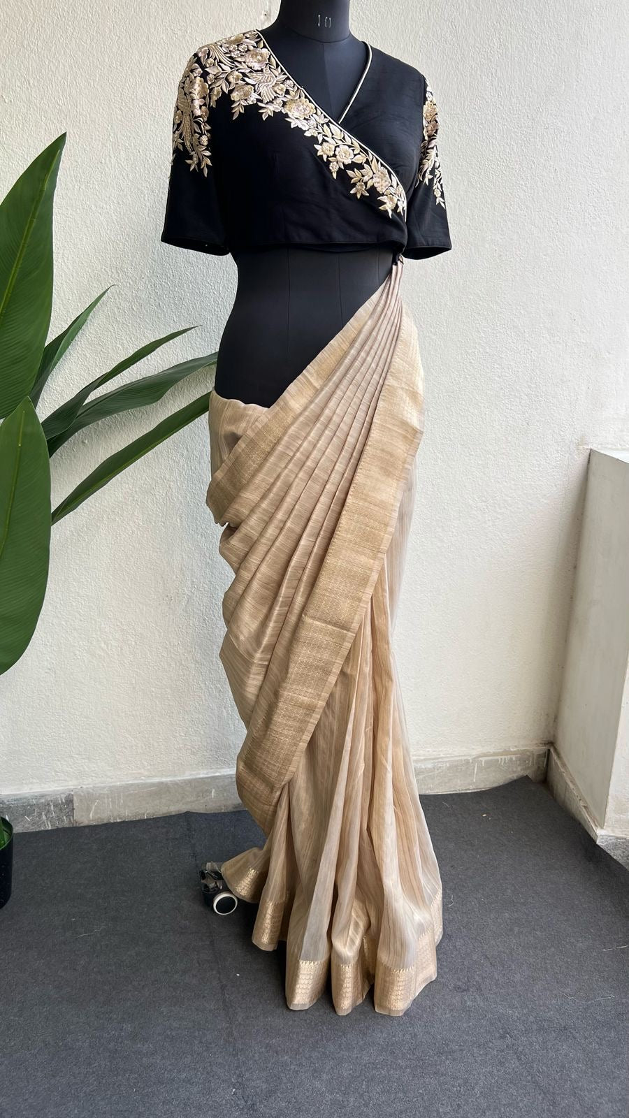 Golden cream tissue saree with black hand work blouse