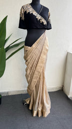 Golden cream tissue saree with black hand work blouse