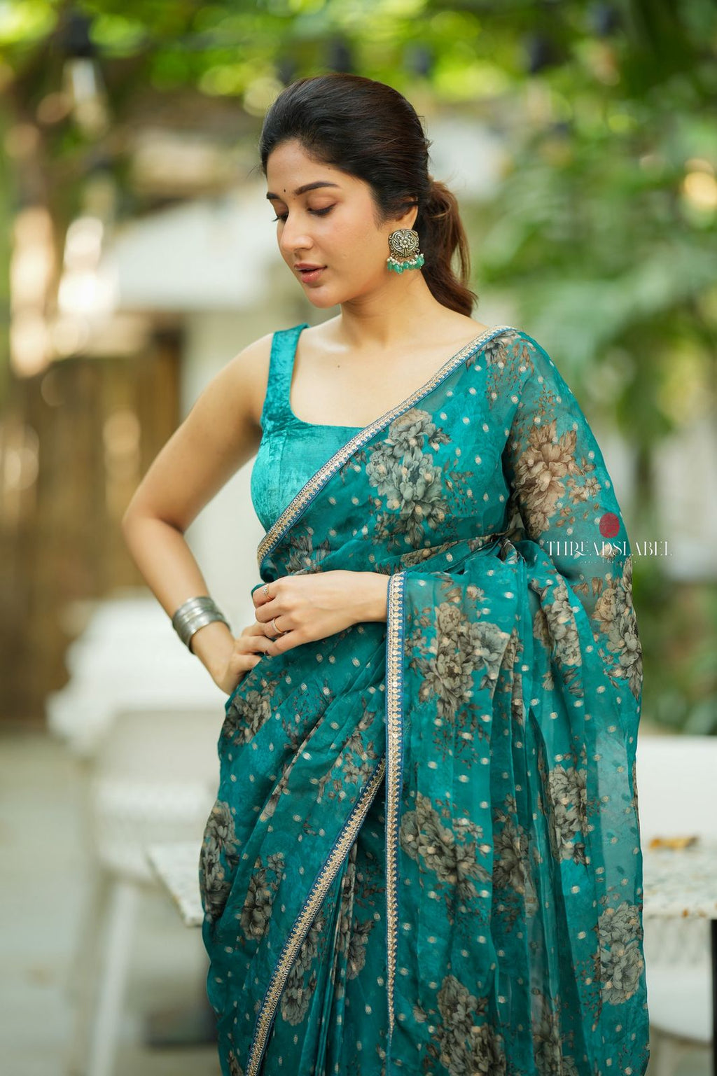 Peacock blue organza saree with velvet blouse