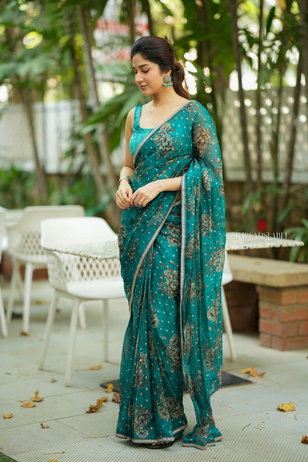 Peacock blue organza saree with velvet blouse