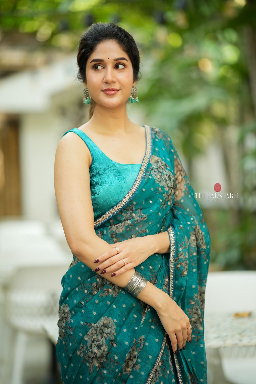 Peacock blue organza saree with velvet blouse