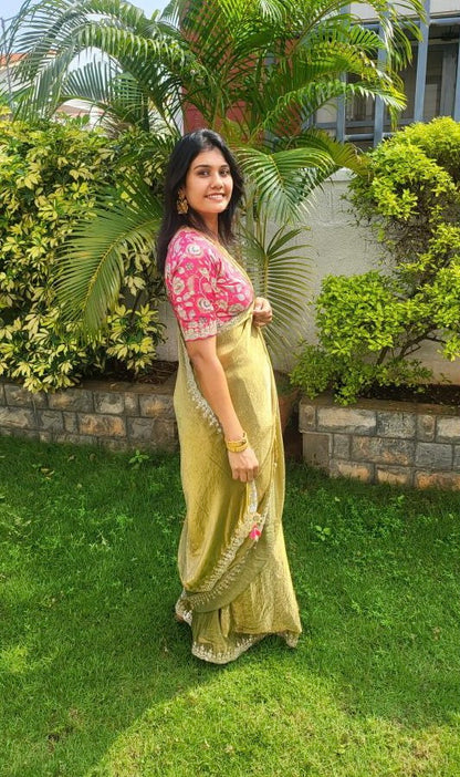 Green soft tissue saree with pink floral embroidered blouse