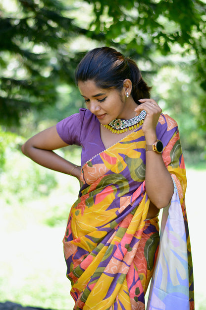 Yellow floral satin saree with purple jewel neck hand work blouse