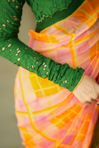 Orange viscose jute saree with green hakoba blouse