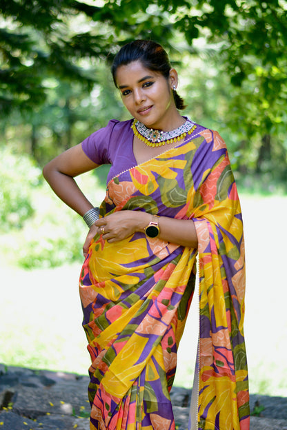 Yellow floral satin saree with purple jewel neck hand work blouse