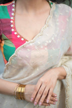 Beige georgette tissue saree with multi hand work blouse