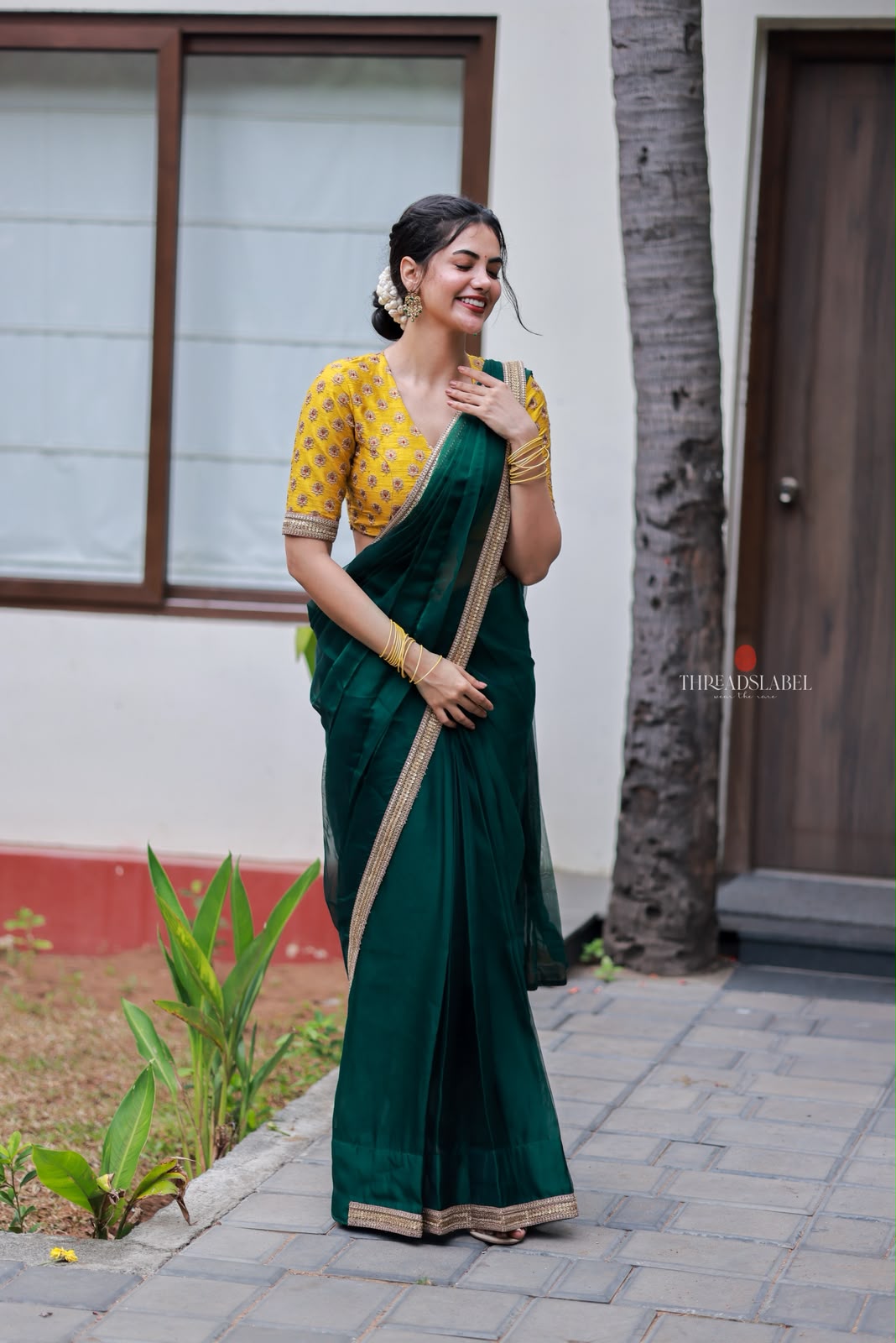 Green organza saree with yellow hand work blouse