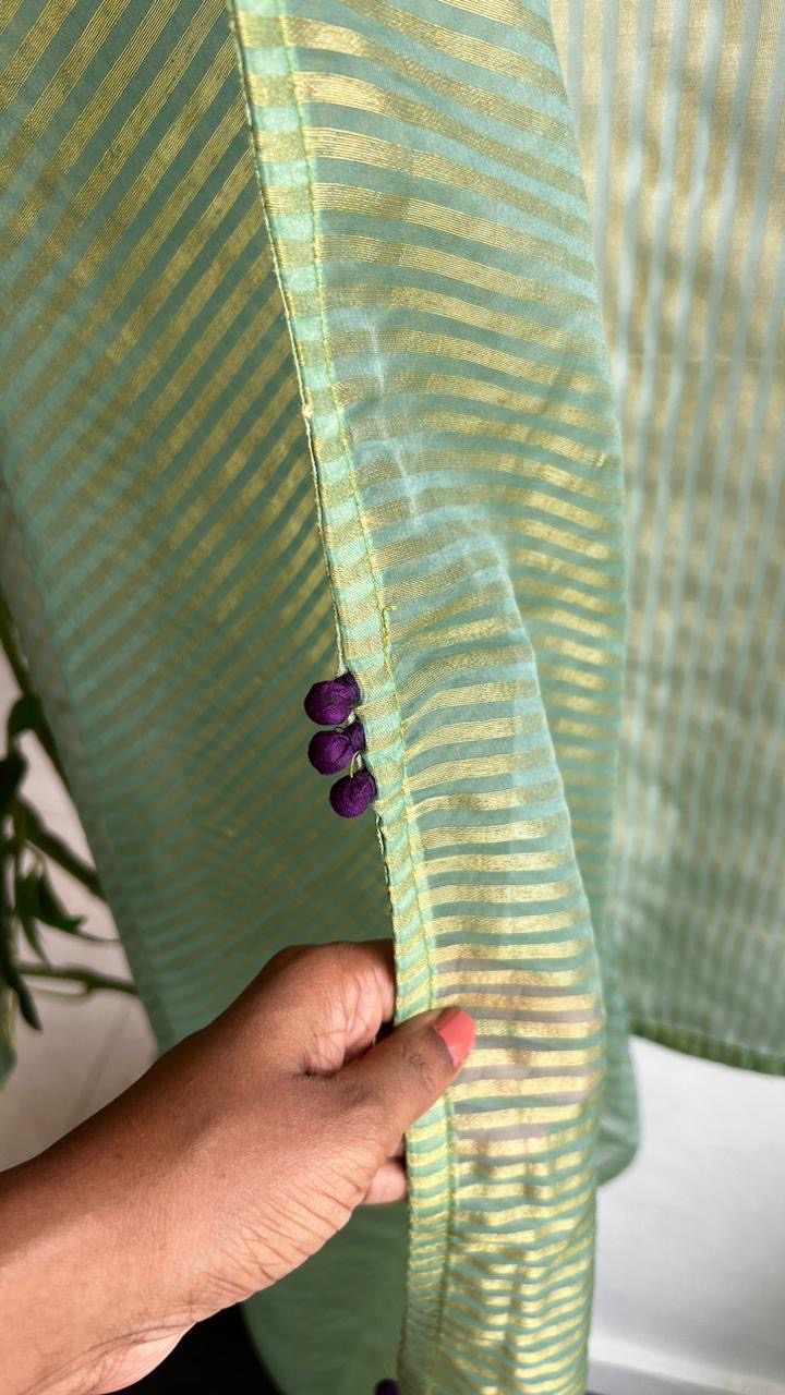Green stripped tissue saree with purple floral hand work blouse