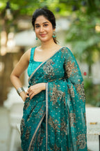 Peacock blue organza saree with velvet blouse