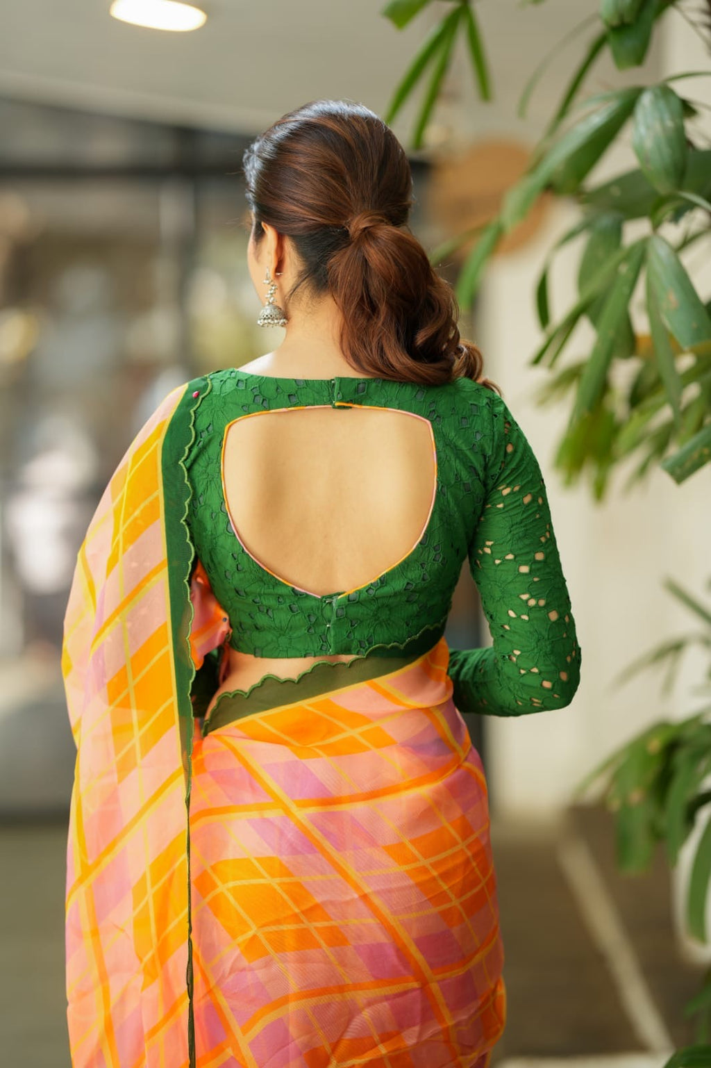 Orange viscose jute saree with green hakoba blouse