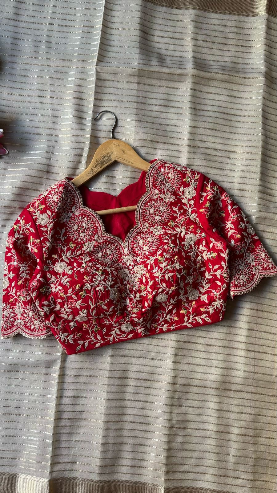 Cream tissue stripped saree with red silk hand work blouse