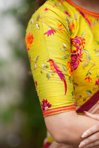 Antique gold tissue saree with parrot handwork blouse