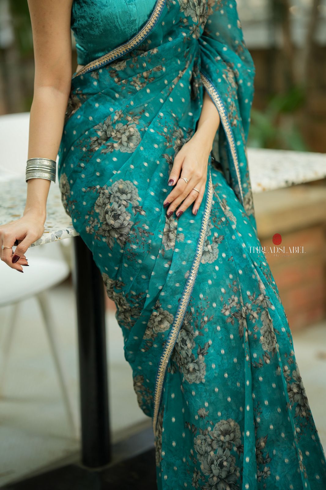 Peacock blue organza saree with velvet blouse