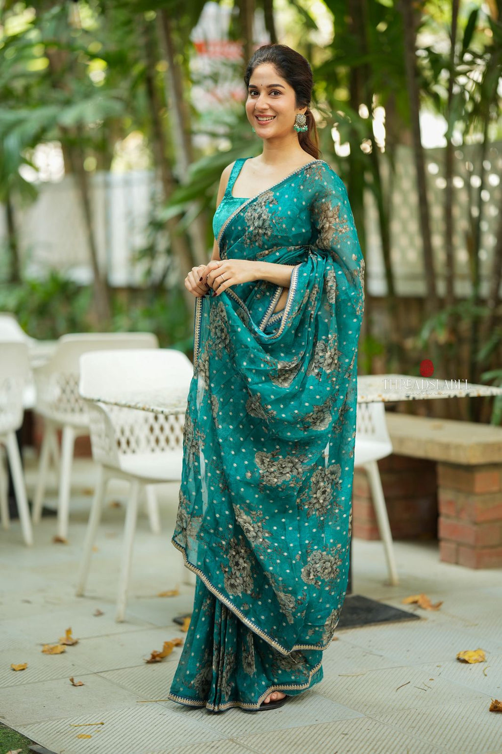 Peacock blue organza saree with velvet blouse