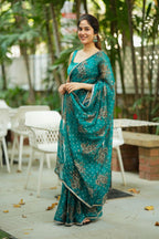 Peacock blue organza saree with velvet blouse