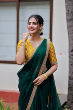 Green organza saree with yellow hand work blouse