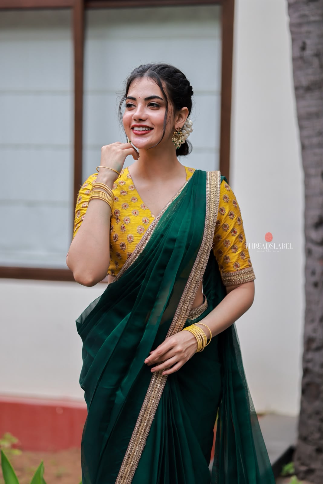 Green organza saree with yellow hand work blouse