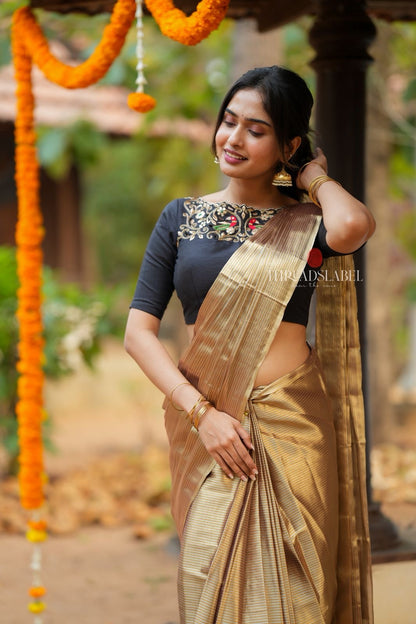Golden tissue saree with black hand work blouse