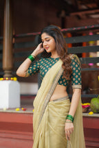 Gold tissue saree with green hand work blouse