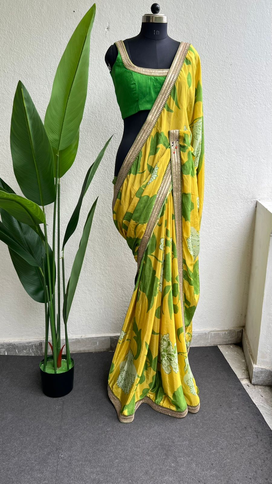 Yellow viscose saree with green silk embroidered blouse