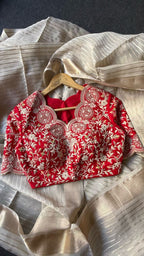 Cream tissue stripped saree with red silk hand work blouse