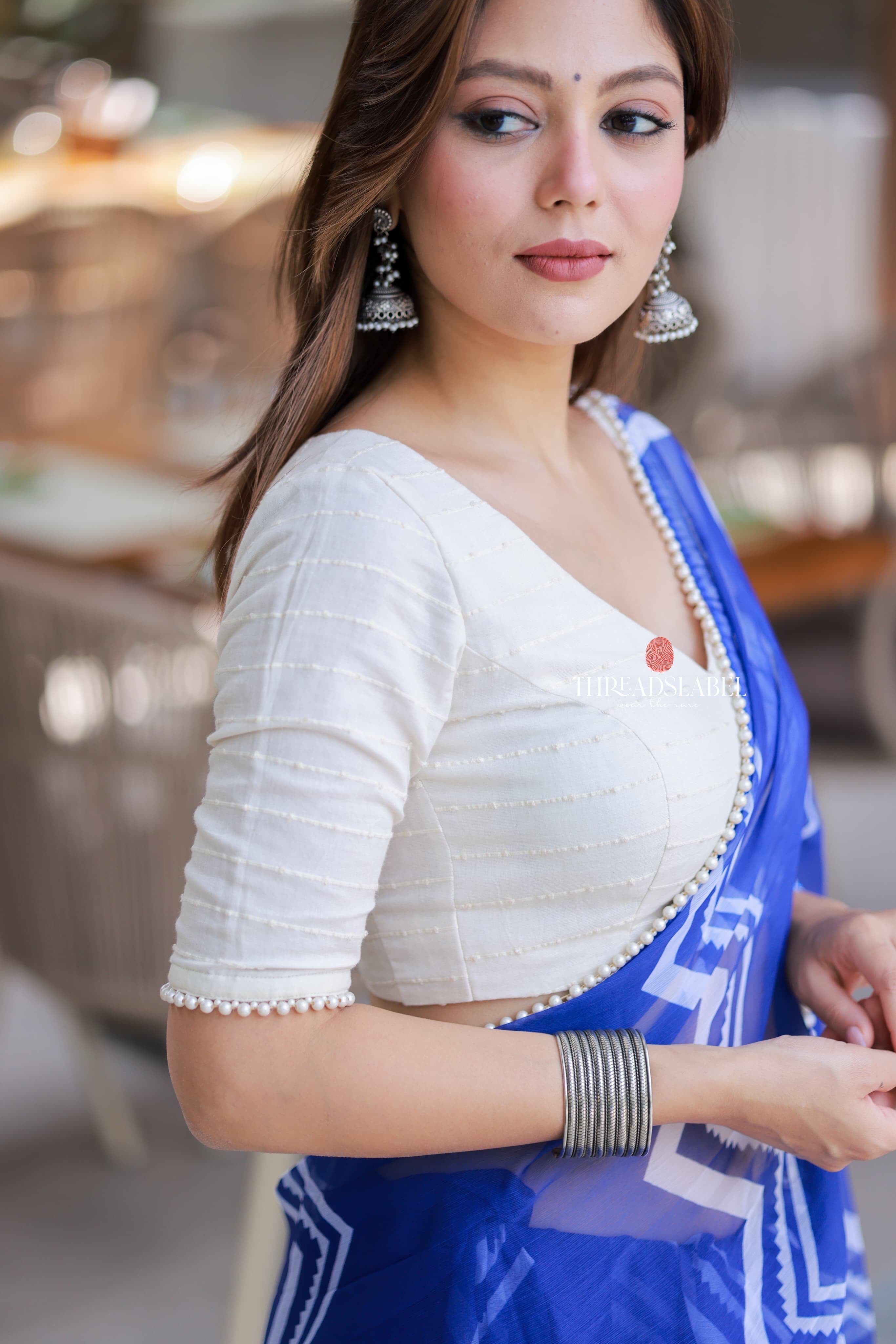 Blue chiffon saree with white embroidery blouse