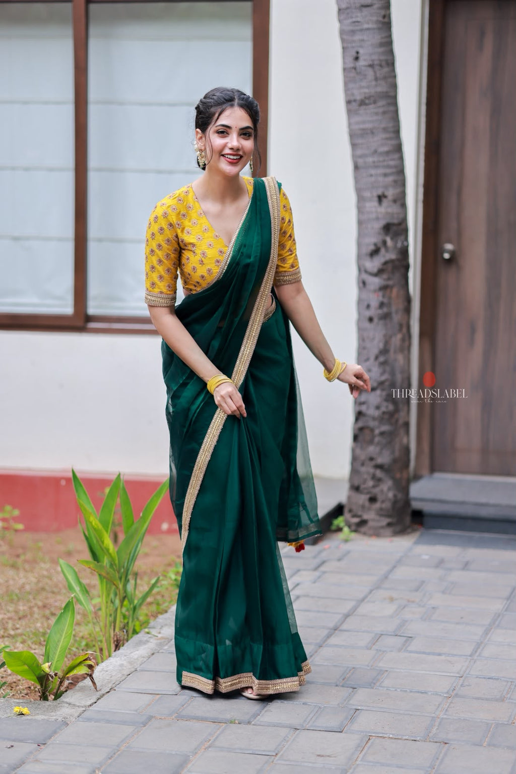 Green organza saree with yellow hand work blouse