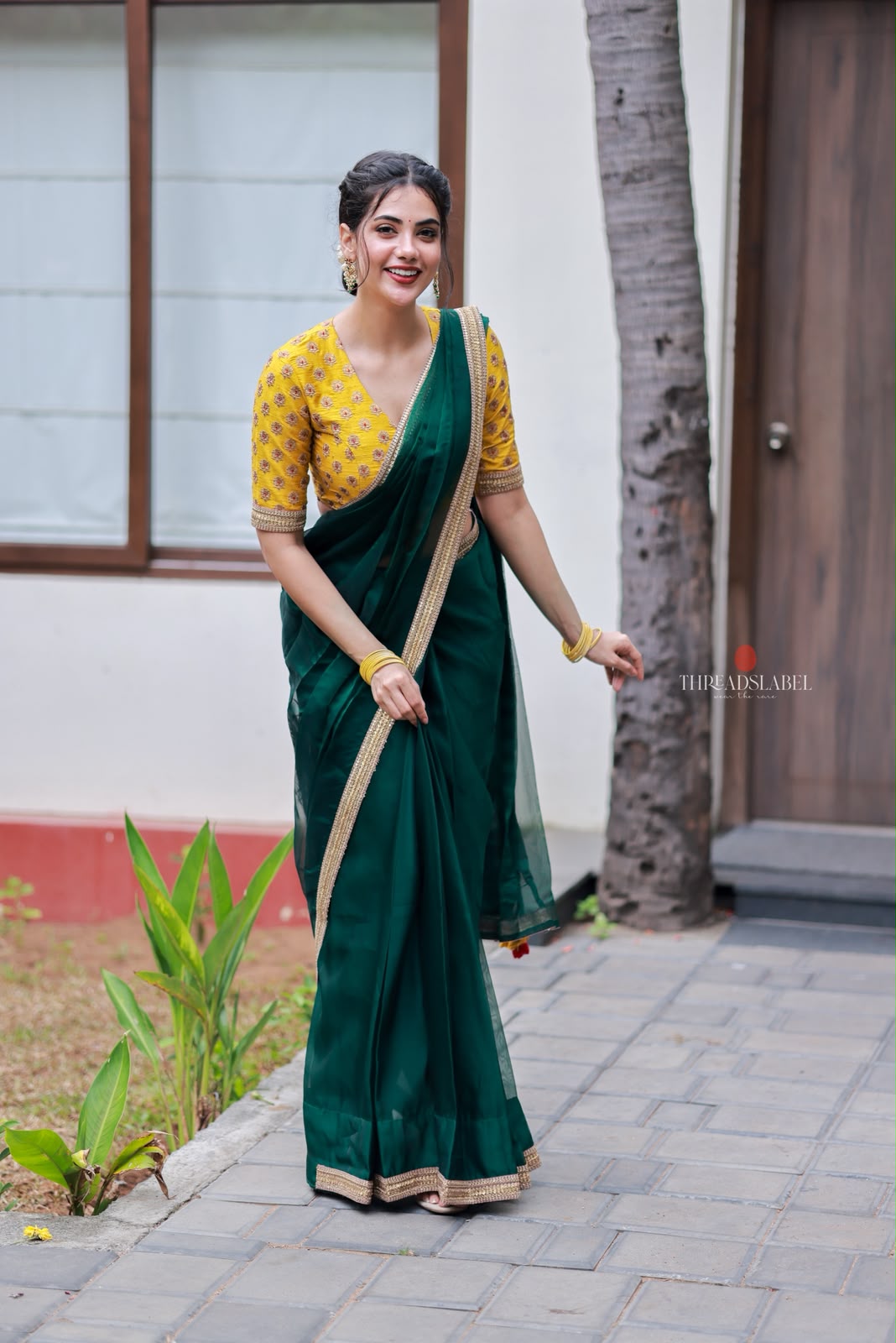 Green organza saree with yellow hand work blouse