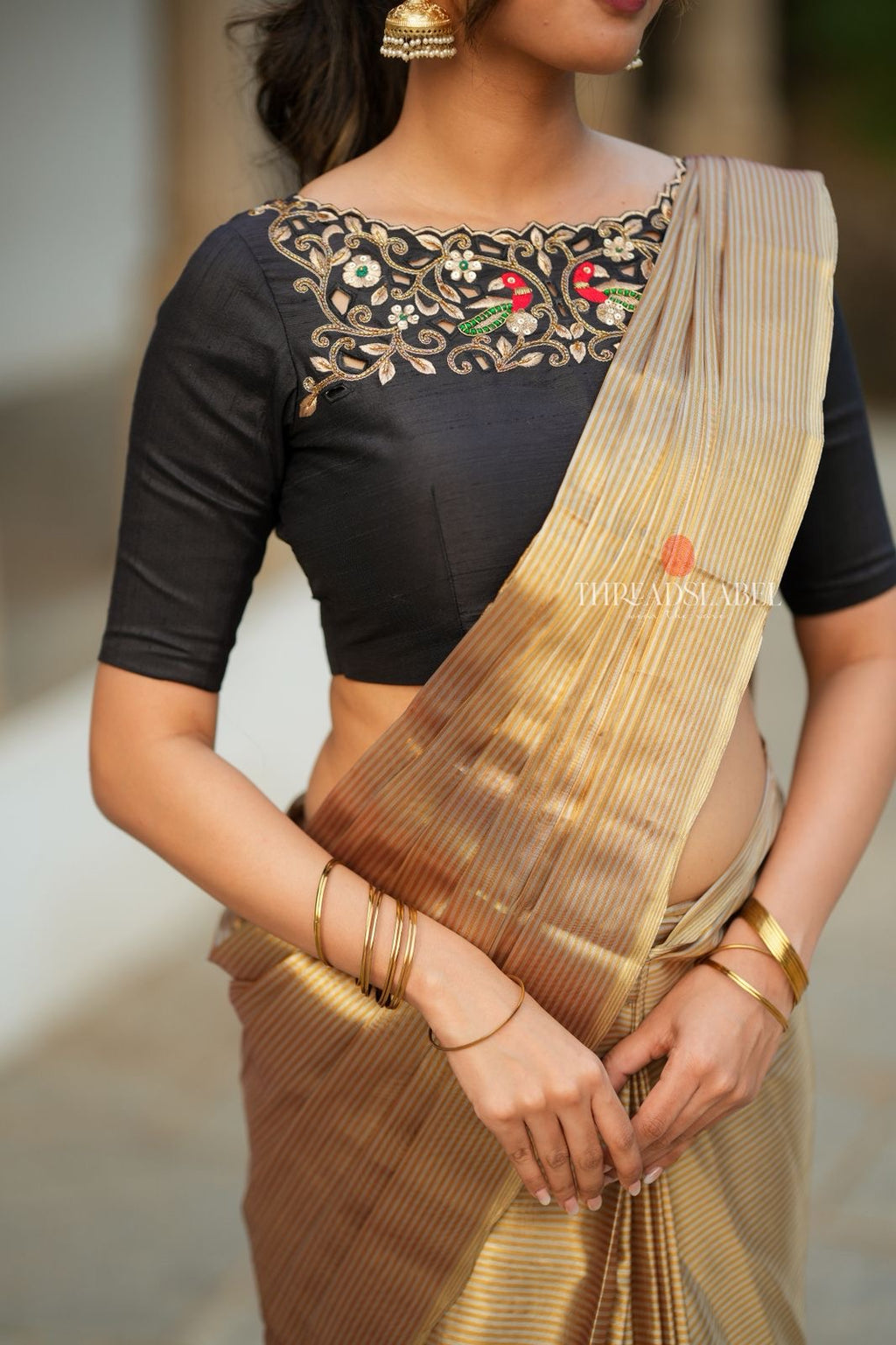 Golden tissue saree with black hand work blouse