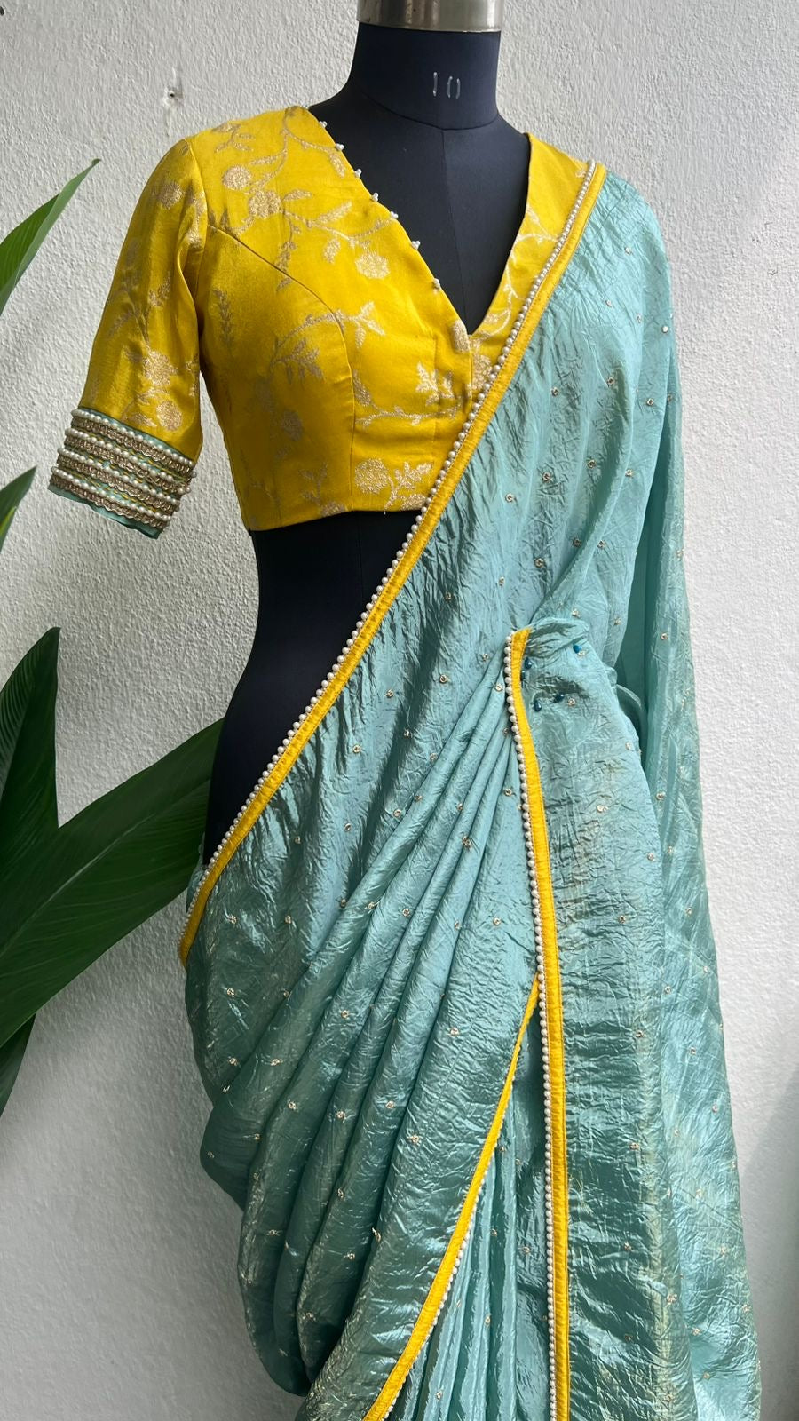 Blue glass tissue saree with yellow banarasi blouse