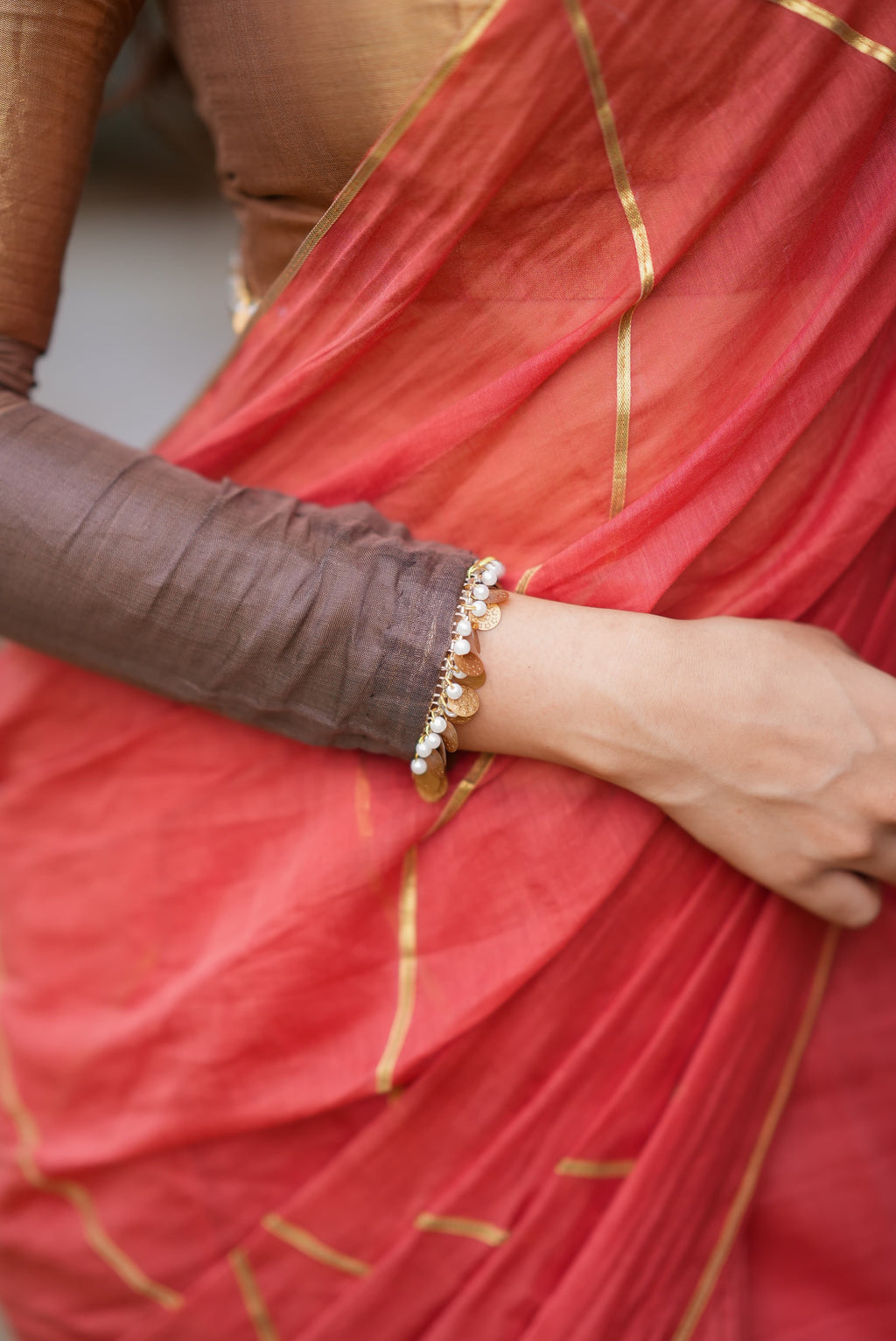 Orange rust saree with tissue handwork blouse