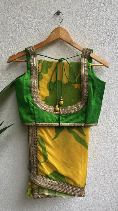 Yellow viscose saree with green silk embroidered blouse