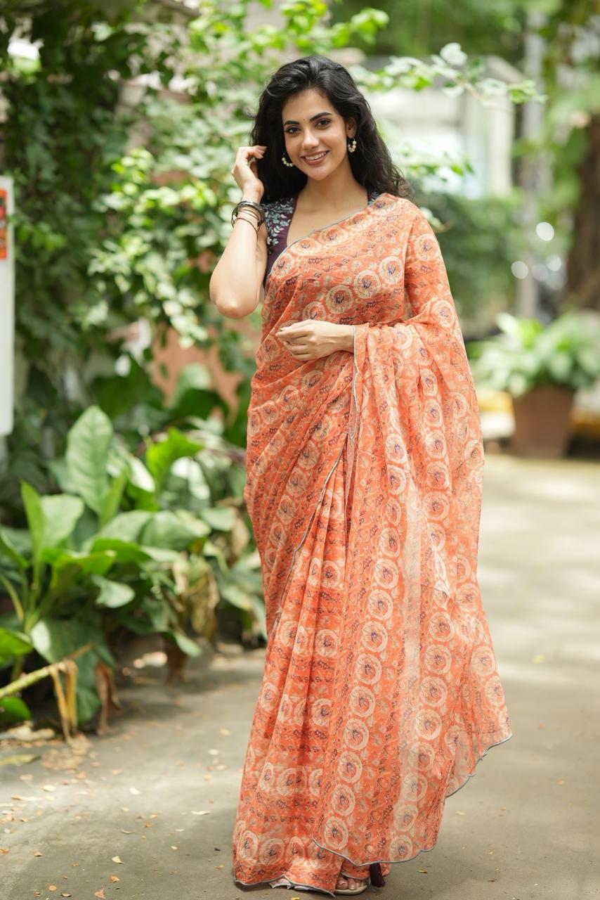 Pastel peach chiffon saree with brown hand work blouse
