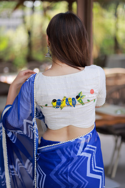 Blue chiffon saree with white embroidery blouse