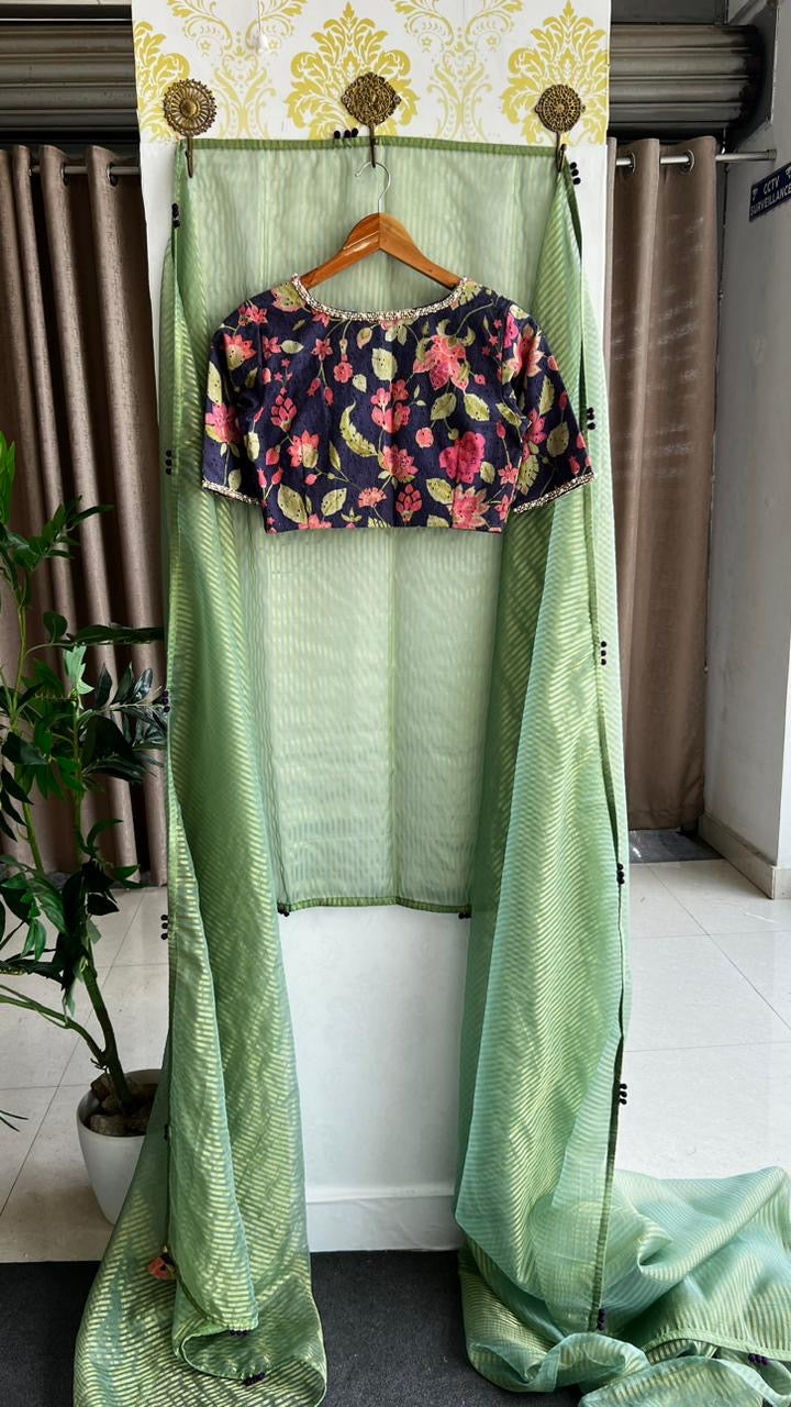 Green stripped tissue saree with purple floral hand work blouse