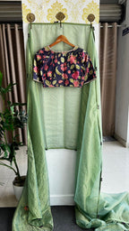 Green stripped tissue saree with purple floral hand work blouse