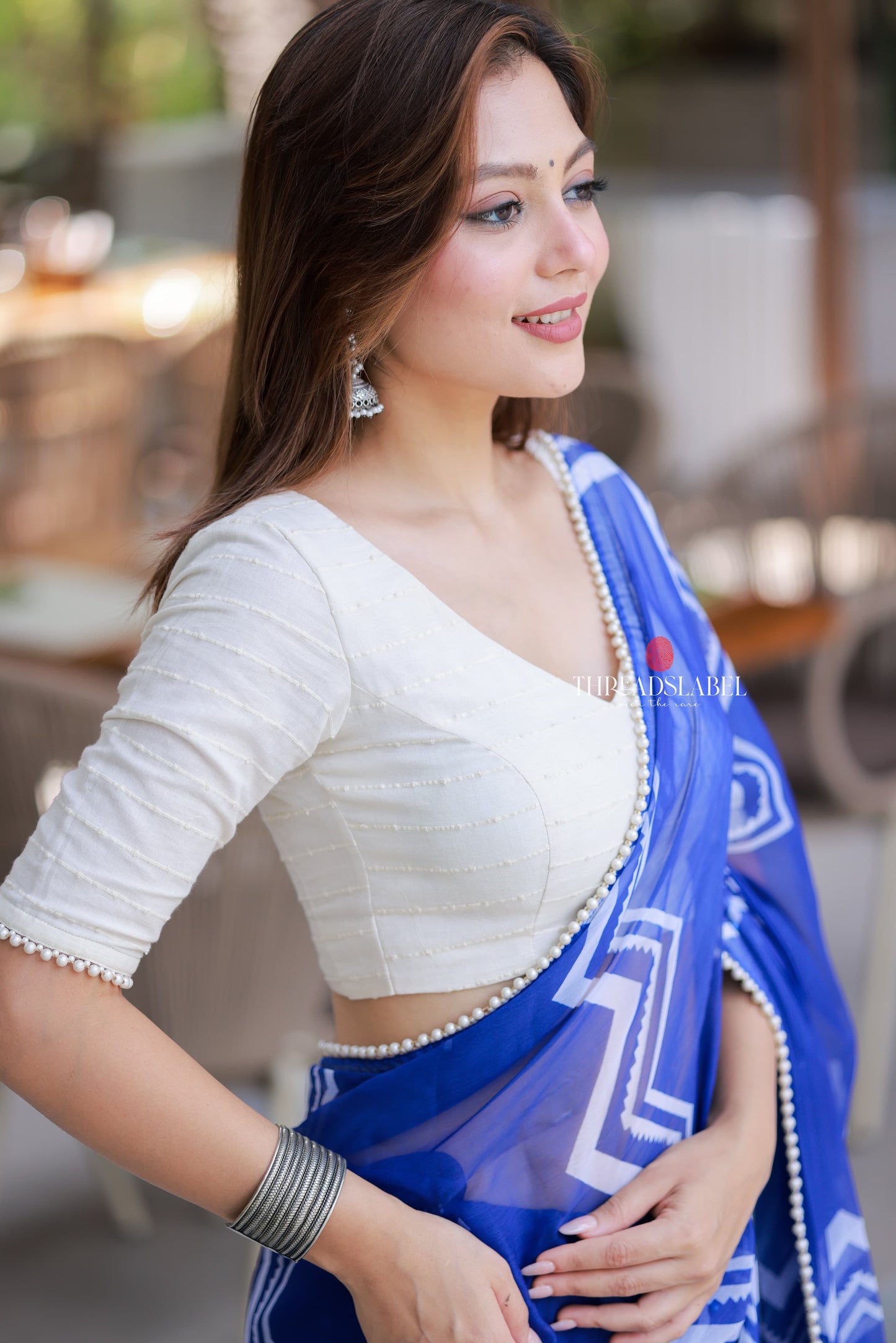 Blue chiffon saree with white embroidery blouse