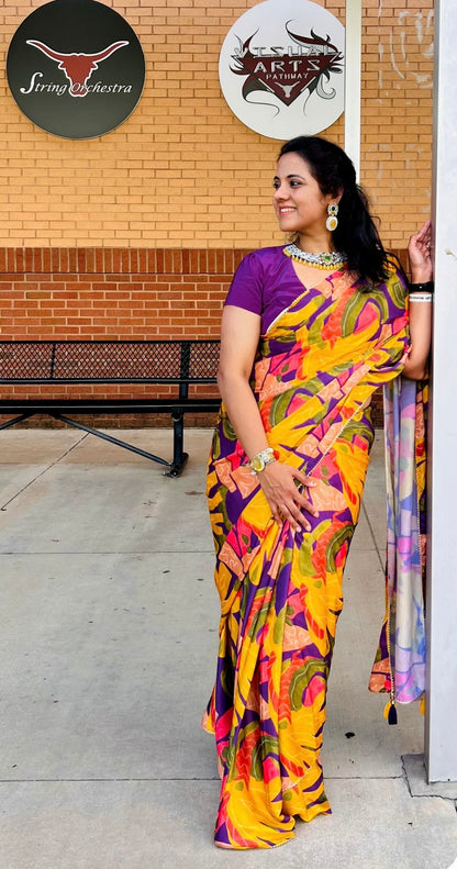 Yellow floral satin saree with purple jewel neck hand work blouse