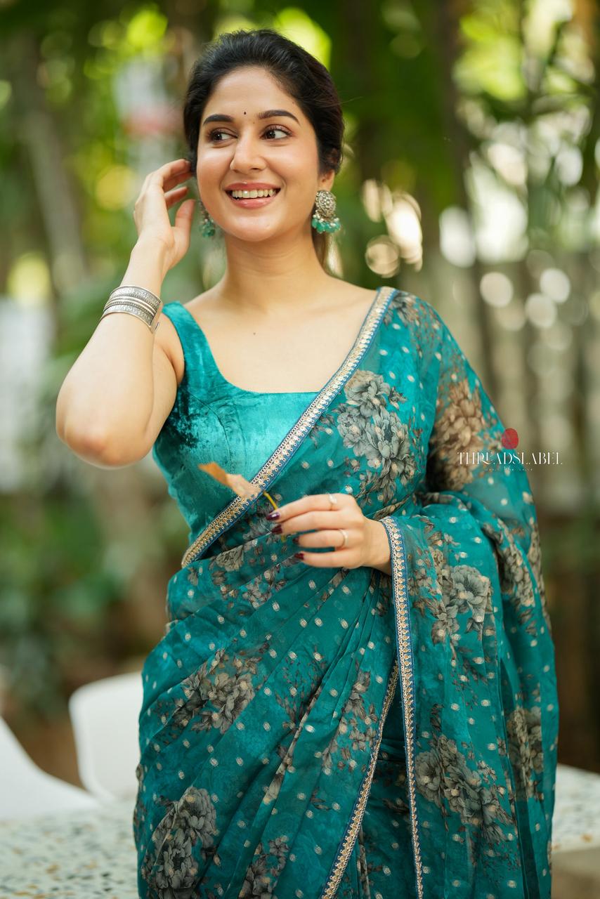 Peacock blue organza saree with velvet blouse