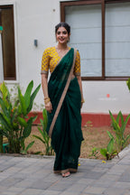 Green organza saree with yellow hand work blouse