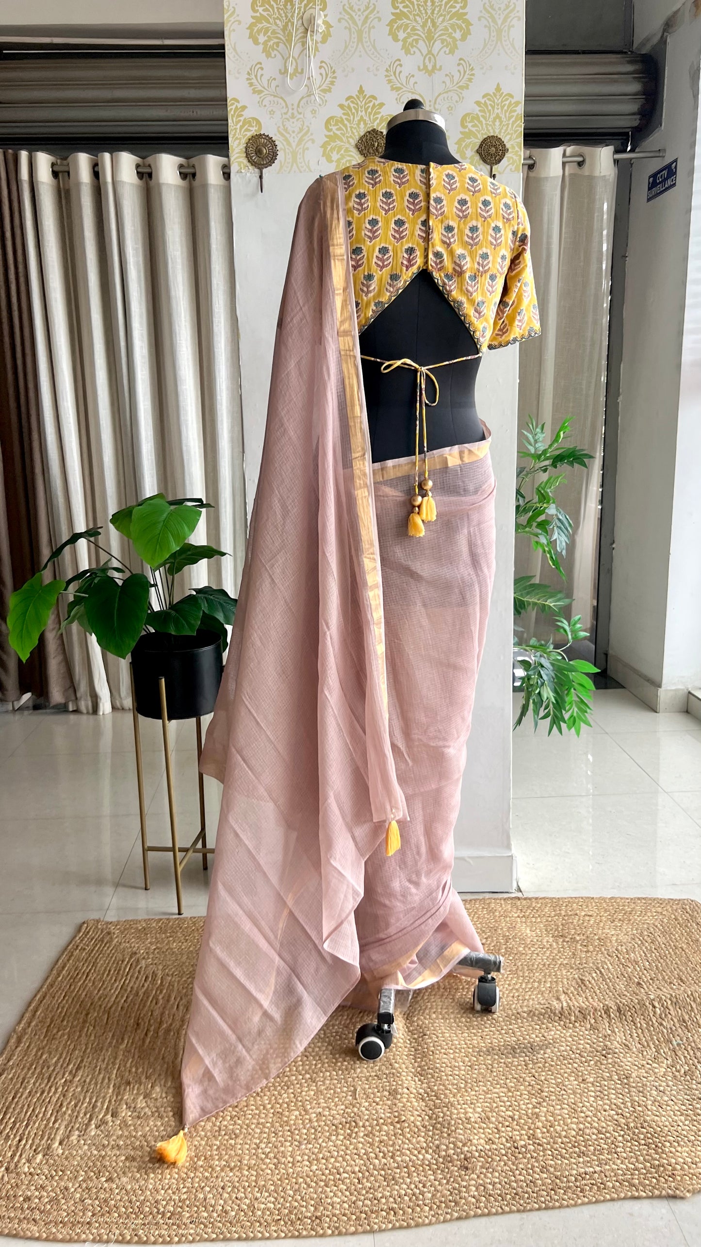 Light peach mul kota saree with yellow hand work blouse
