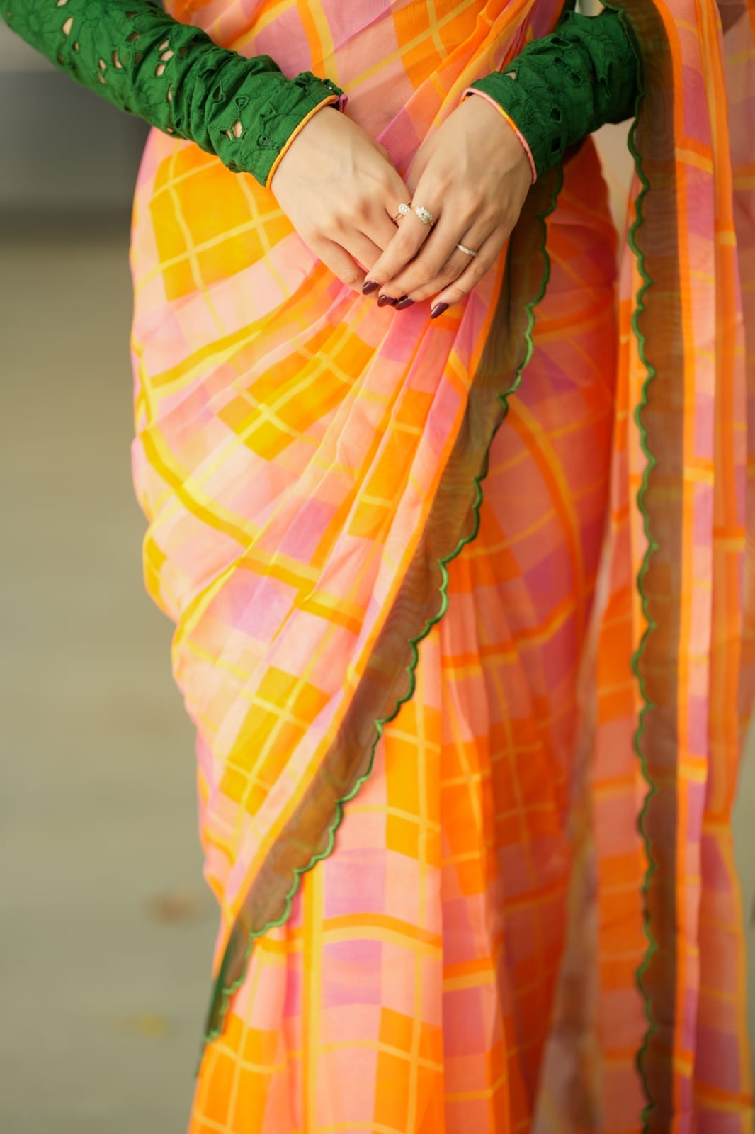 Orange viscose jute saree with green hakoba blouse