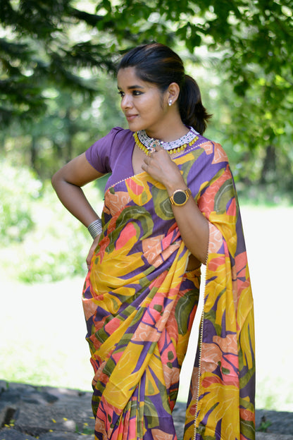 Yellow floral satin saree with purple jewel neck hand work blouse