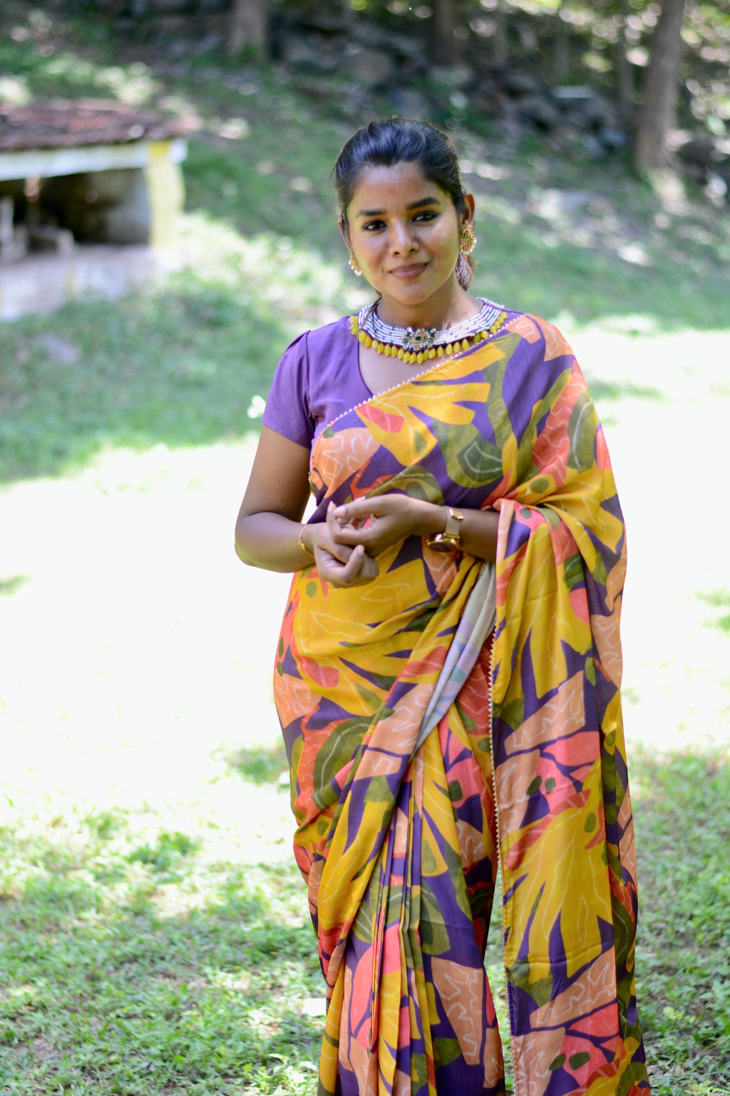 Yellow floral satin saree with purple jewel neck hand work blouse