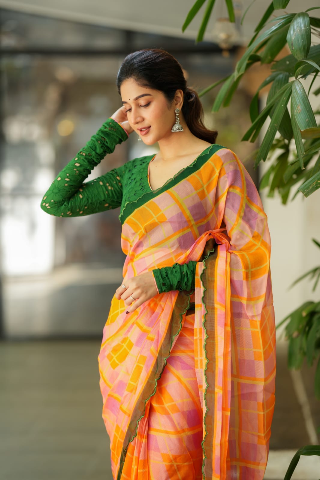 Orange viscose jute saree with green hakoba blouse
