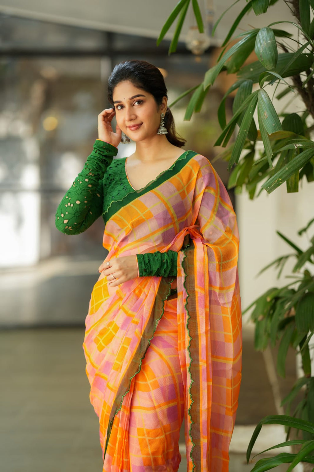 Orange viscose jute saree with green hakoba blouse
