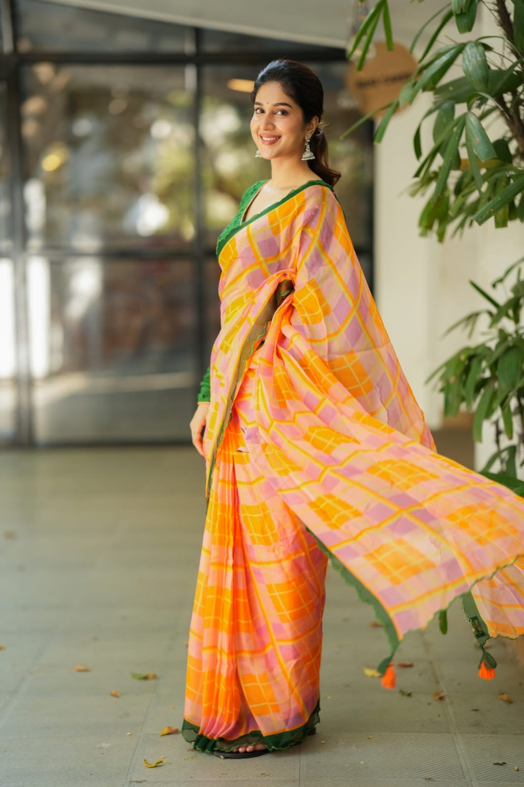 Orange viscose jute saree with green hakoba blouse