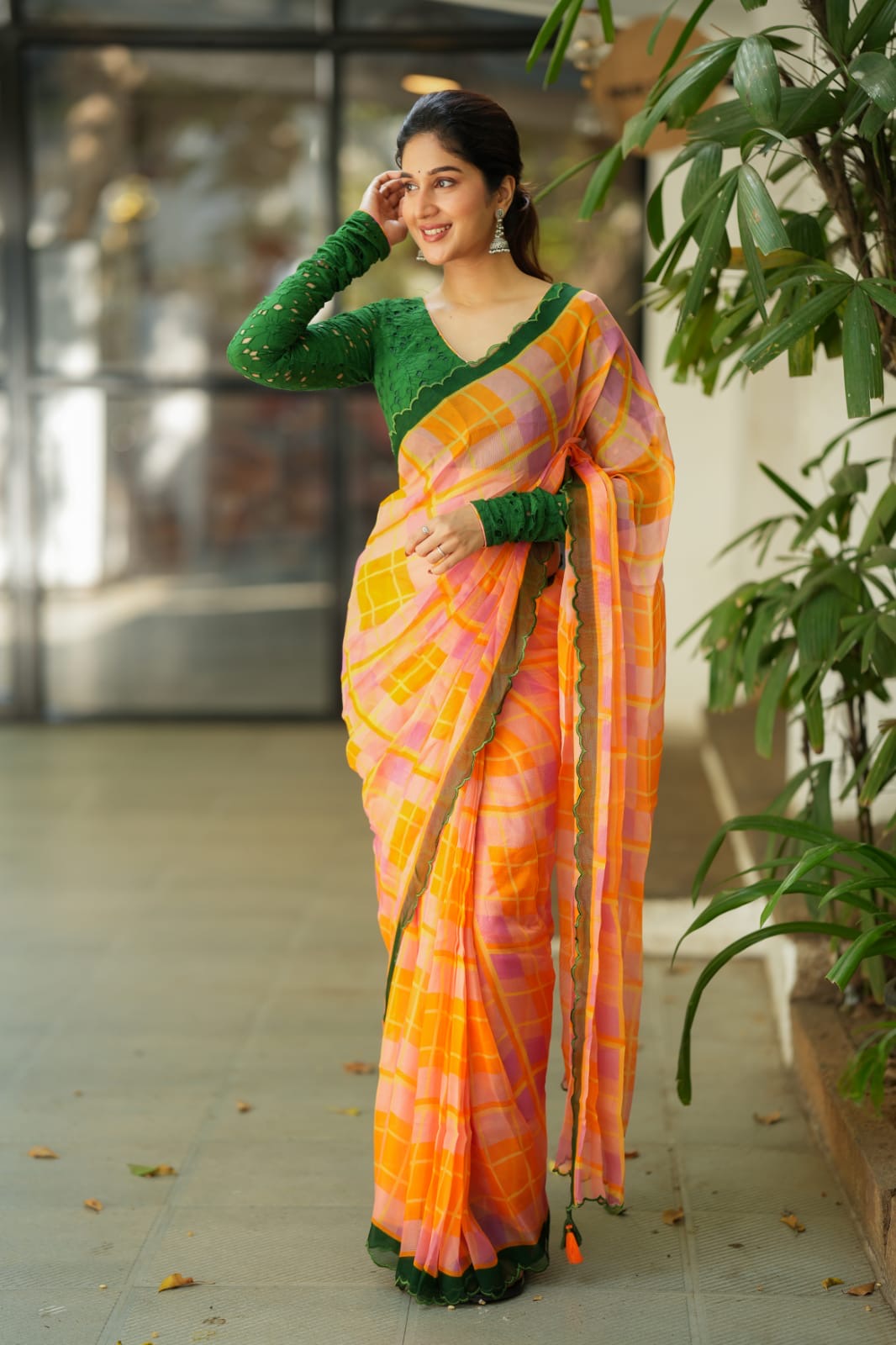 Orange viscose jute saree with green hakoba blouse