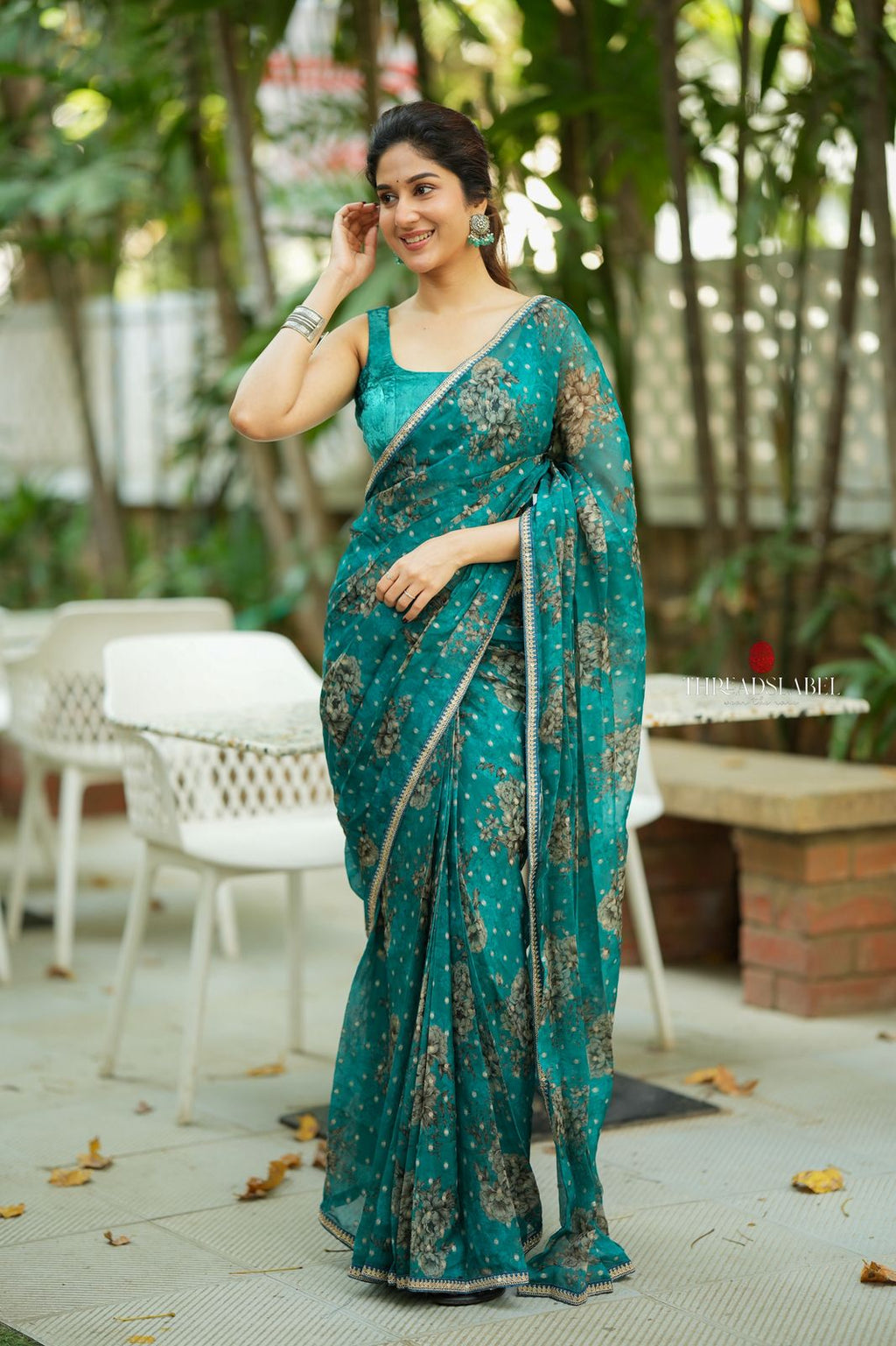 Peacock blue organza saree with velvet blouse
