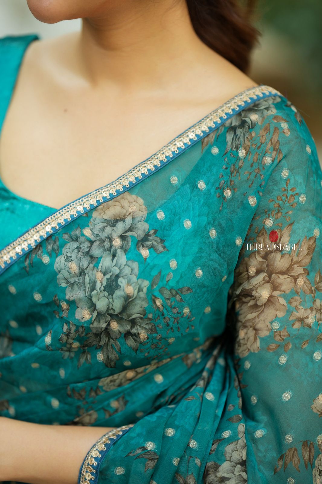 Peacock blue organza saree with velvet blouse